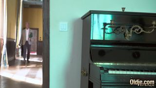 Lusty crimson haired stunner is throating an older fellow's hard-on to pay some of the family's debts