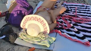 MILF with small tits touching her pussy in public beach