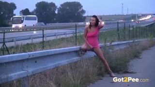 Naked babe with nice tits is pissing outside, while a horny voyeur is recording a video