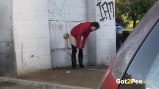 Naked babe with nice tits is pissing outside, while a horny voyeur is recording a video