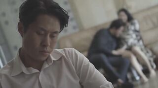 While the husband sleeps in a wheelchair, the wife and her lover caress each other